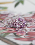 Front view: The Avalanche Berry Mousse Ring against a colored background, emphasizing the soft lilac tones of the sapphires and the warm yellow gold. Made in Montreal, Canada, by Bena Jewelry.