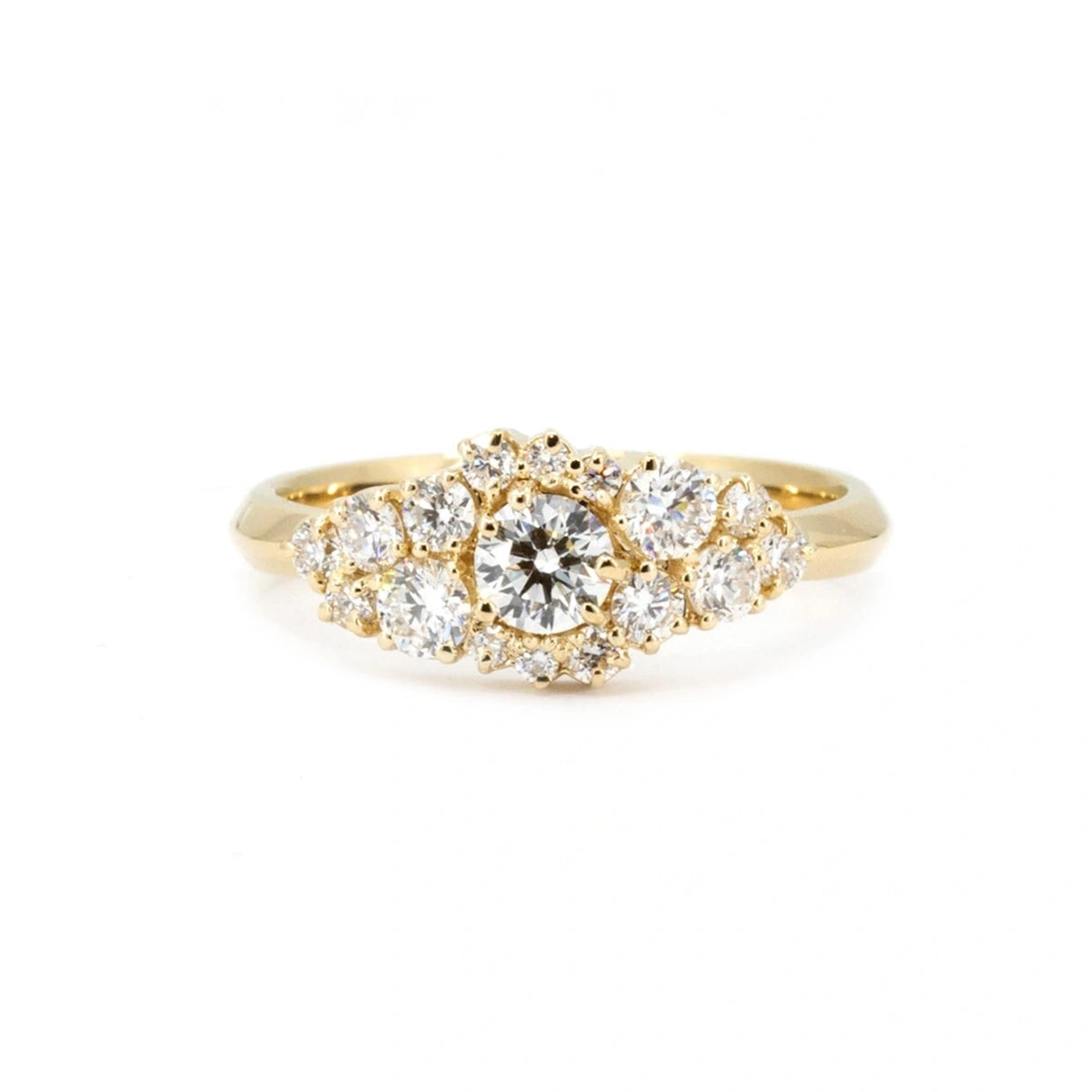 Front view of a unique yellow gold ring set with 17 lab-grown round brilliant diamonds. This handcrafted statement piece is photographed on a white background and available through Bena Jewelry in Montreal, Canada.