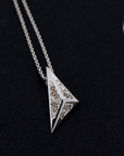 Modern pyramidal pendant in white gold with lab-grown diamonds, set against a dark background. Unique designer jewelry by Bena Jewelry, handmade in Montreal.