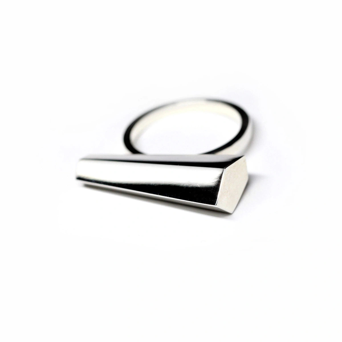 Sturdy ring in white gold on a white background. A Minimalist, modern and elegant piece of jewelry. Find this gender-neutral ring that fits both classic and edgy wardrobes online, or at Bena Jewelry's.