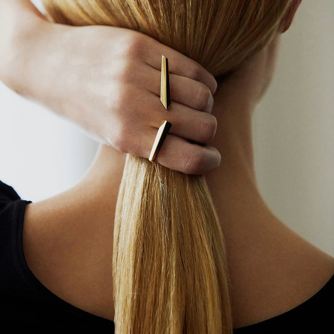 Two rings from Bena Jewelry’s Edgy Collection worn by a woman seen from the back. Allure ring and Sturdy ring are both minimalist, modern and elegant. Find these gender-neutral pieces of jewelry that fits both classic and edgy Bena Jewelry's.