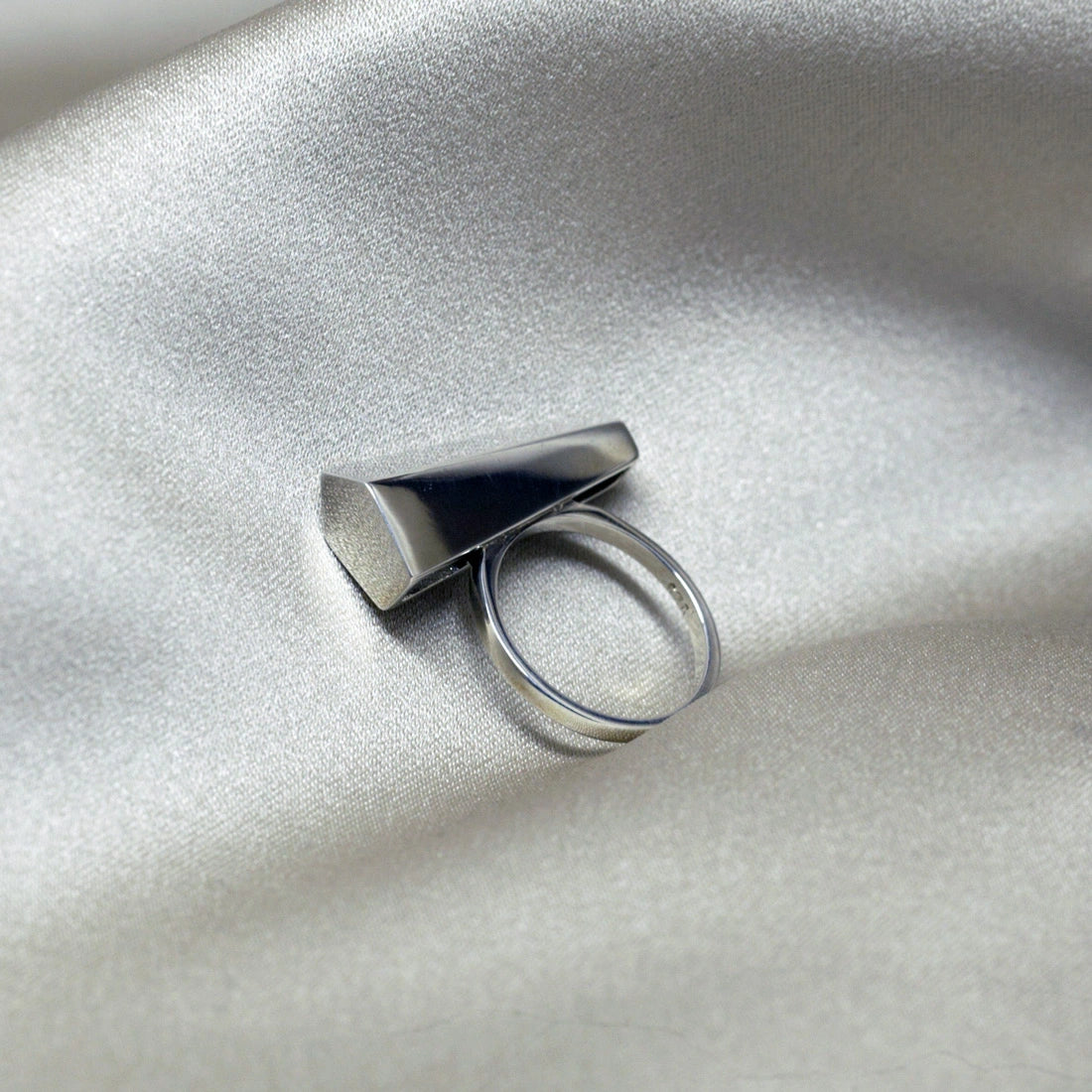 Canadian jewelry designer Bena Jewelry's white gold Sturdy ring, photographed in close-up on a satin fabric. Modern and predominantly handcrafted jewelry available online or at our jewellery store in Montreal's Little Italy.