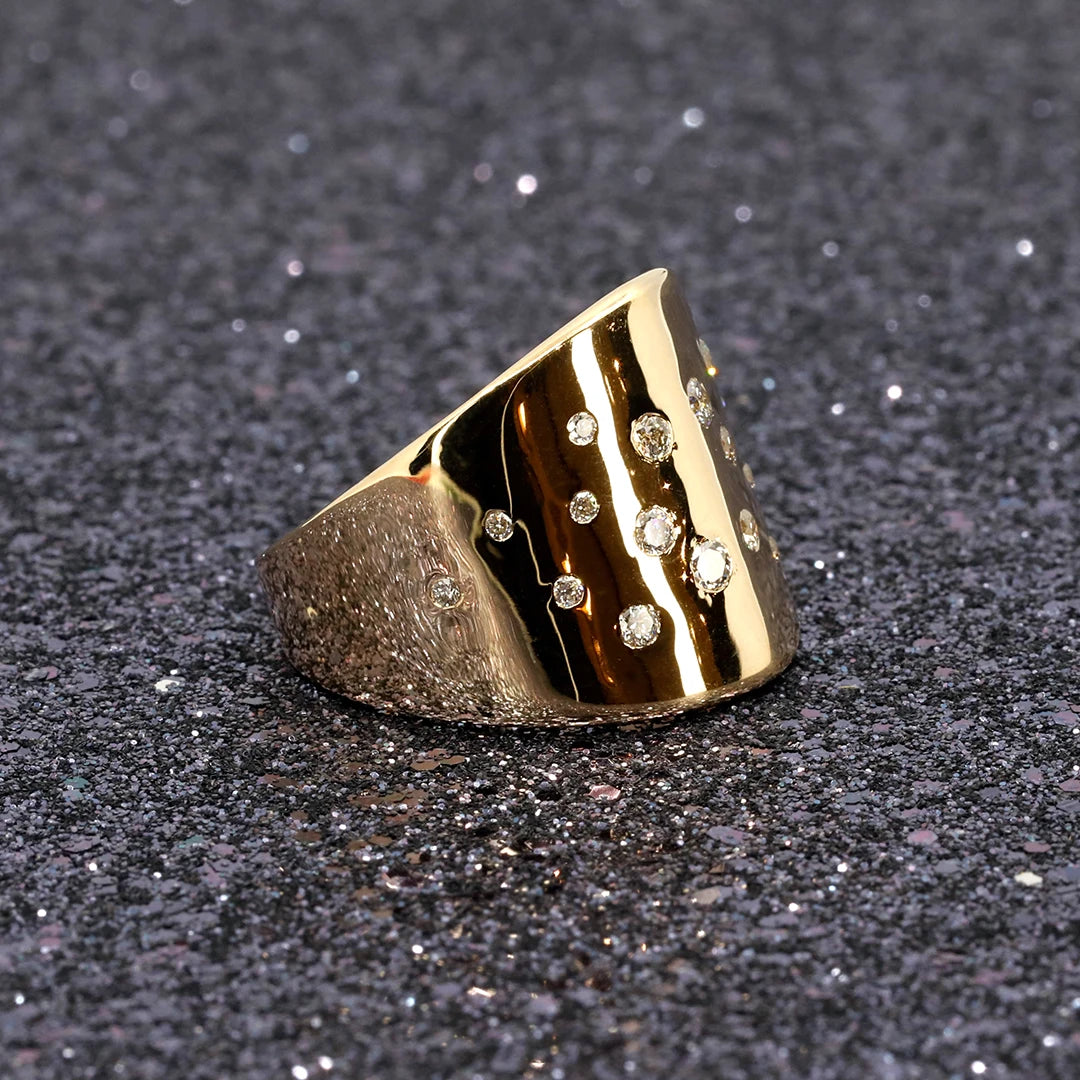Diiamond Lump Ring in yellow gold with a bold design, showcased with sparkling brilliance on a dark glitter background, by Bena Jewelry.