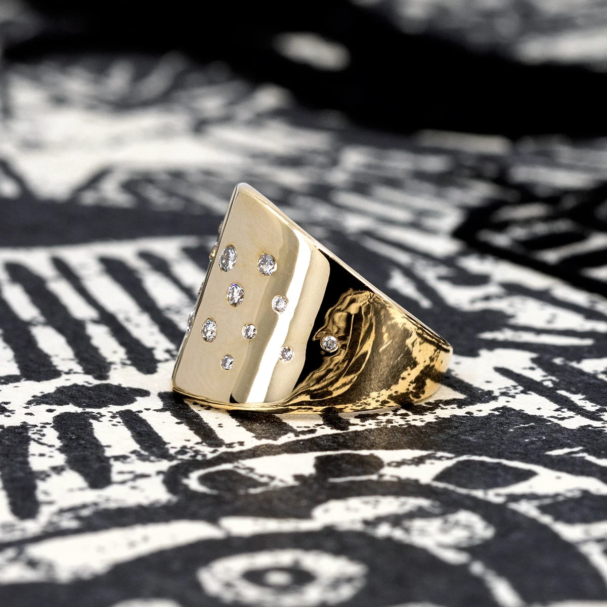 Side view of Diamond Lump Ring featuring brilliant diamonds in yellow gold, displayed against a black-and-white background, by Bena Jewelry.