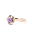 Three-quarter view of a rose gold sapphire ring by Bena Jewelry featuring an opalescent purple sapphire surrounded by champagne diamonds. Handmade designer jewelry from Montreal.