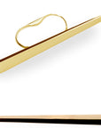 The Grand Punch ring bears the recognizable signature of Bena Jewelry: a play of volumes and a study of shapes that highlights the contrast between light and shadow. It is seen here on a white background from two different angles. It's a long, geometric piece in solid yellow gold, the full width of a fist.