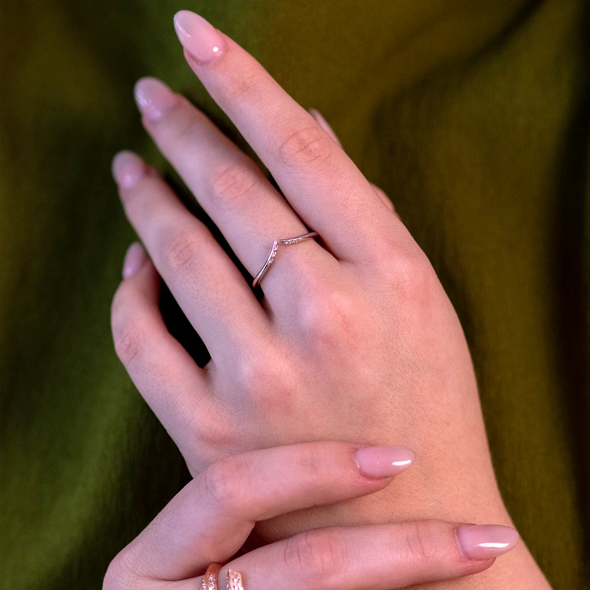 Cose-up of a woman’s hand wearing the Kink white gold open diamond ring, showcasing its edgy and modern design with natural brilliant diamonds by Bena Jewelry, made in Montreal.