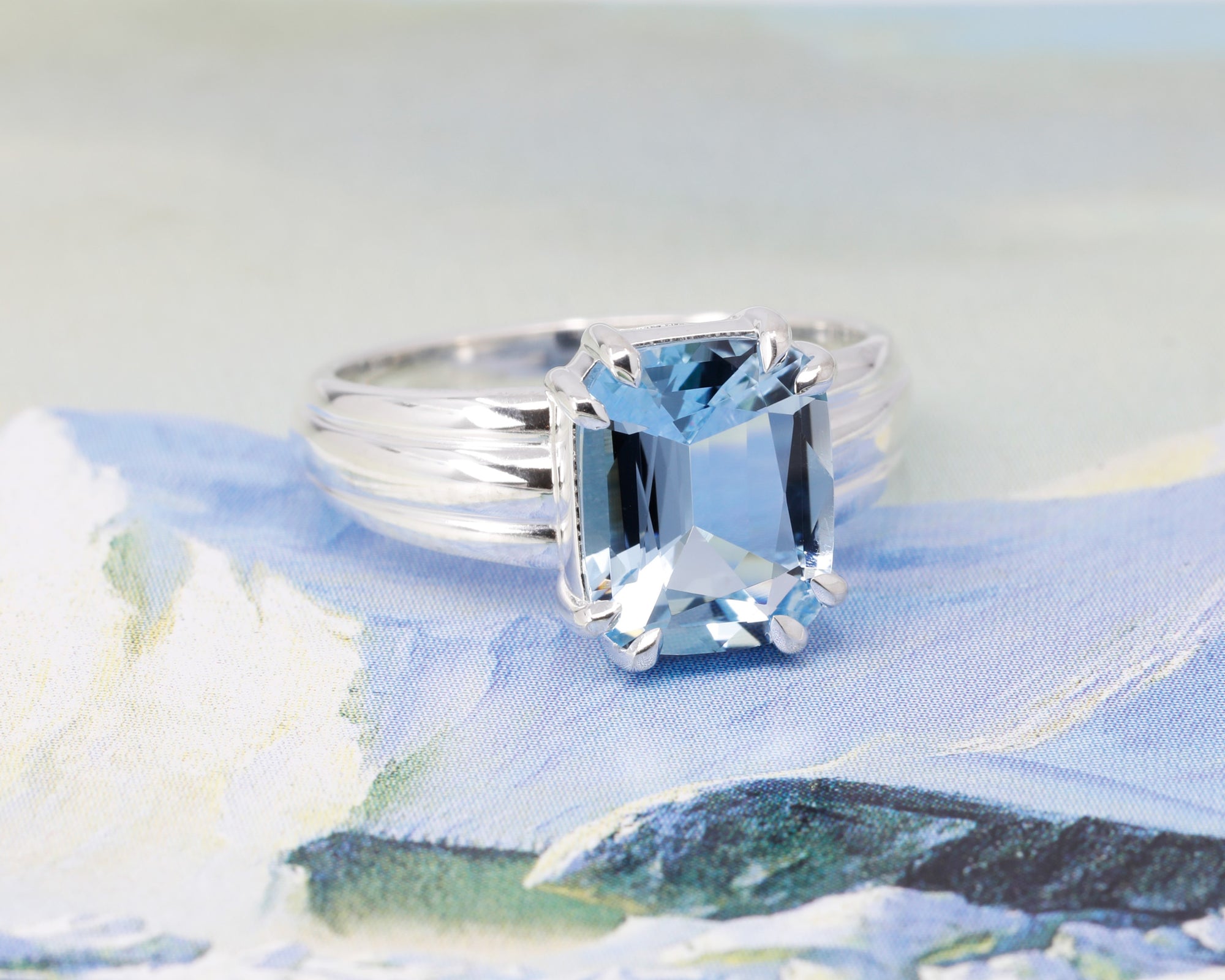 Top view: Captures the aquamarine’s brilliance and its striking presence in the silver setting. Designed by Bena Jewelry, crafted in Montreal, Canada.