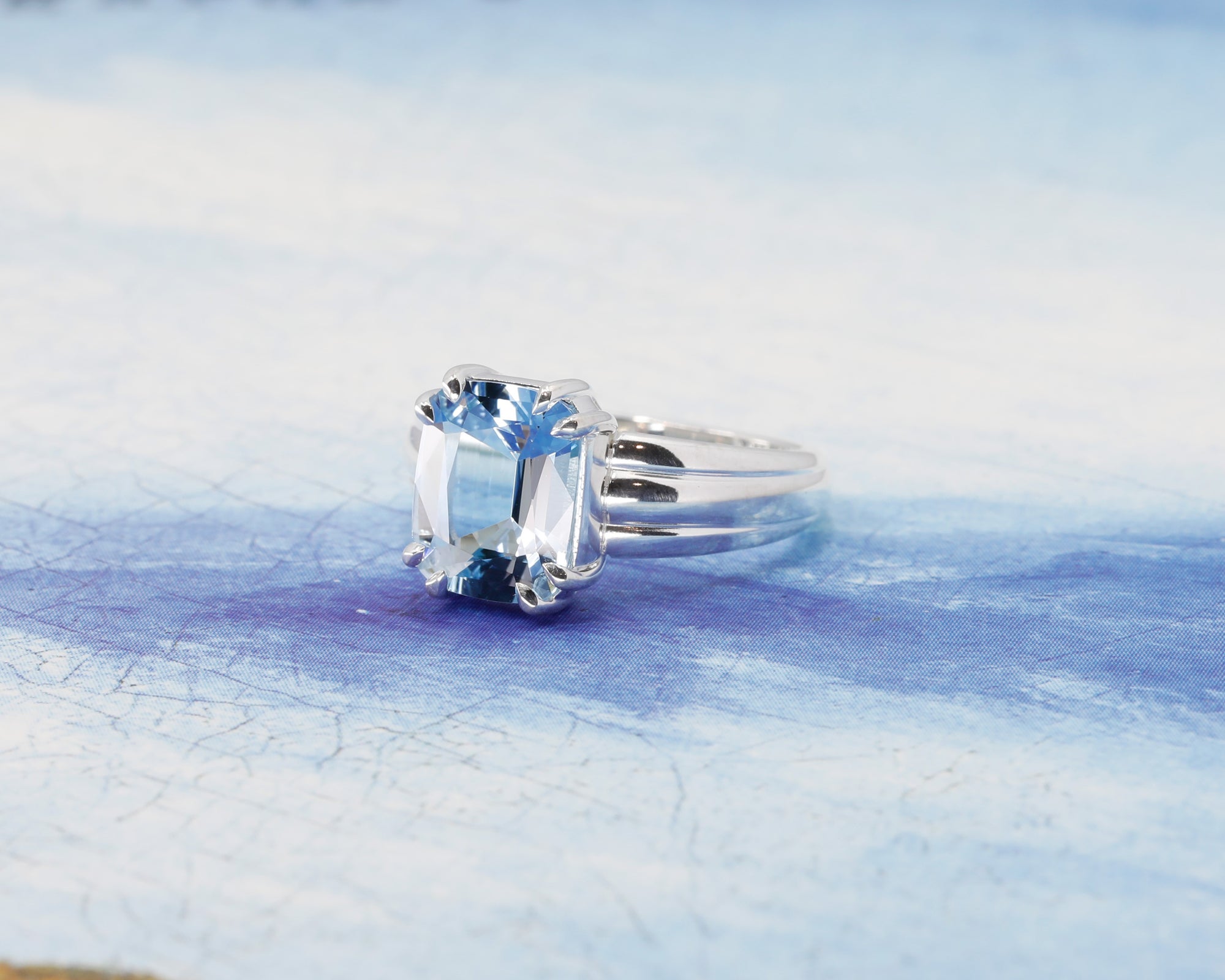 Close-up: Focuses on the aquamarine’s vibrant sky-blue hue and the smooth silver finish. Made by Bena Jewelry, an independent jeweler in Montreal, Canada.