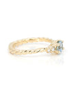 Close-up: Captures the delicate craftsmanship of the aquamarine setting and the polished yellow gold finish. Designed in Montreal, Canada by independent jeweler Bena Jewelry.
