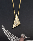 Close-up of the Edgy Pyramidal Pendant in yellow gold, featuring intricate diamond paving and bold triangular lines, set against a sleek black backdrop by Bena Jewelry.