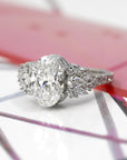 oval shape lab grown diamond and marquise shape designer side gems on platinum and round natural gemstone custom made in montreal by bena jewelry and boutique ruby mardi on multicolor background