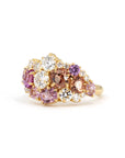 Highlights the dynamic arrangement of peach and pink gemstones with diamonds, set in yellow gold. Custom jewelry by Bena Jewelry, Montreal, Canada.