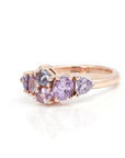 The "Avalanche" ring in 14k rose gold adorned with lilac and purple sapphires, displayed on a white background to highlight the intricate gemstone details and the asymmetrical design. Contemporary jewelry made in Montreal by Bena Jewelry.