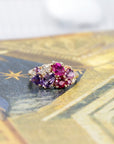Focuses on the rich hues of the violet sapphire and the vibrant rubies against the yellow gold. Made by Bena Jewelry, Montreal, Canada.