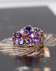 Close-up: Focuses on the vibrant purple tones of the sapphires and the smooth finish of the yellow gold setting. Made by Bena Jewelry, Montreal, Canada.