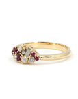 Bena Jewelry Ruby & Salt And Pepper Diamond Avalanche Ring displayed on a white surface, showcasing its one-of-a-kind yellow gold design with rubies and salt and pepper diamonds.