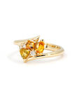 Close-up of the Kink Avalanche ring highlighting the orange and yellow sapphires and diamonds, showcasing the detailed twist design in yellow gold.
