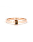 Rose gold ring featuring an orange sapphire and matching diamond band by Bena Jewelry, displayed on a white background.