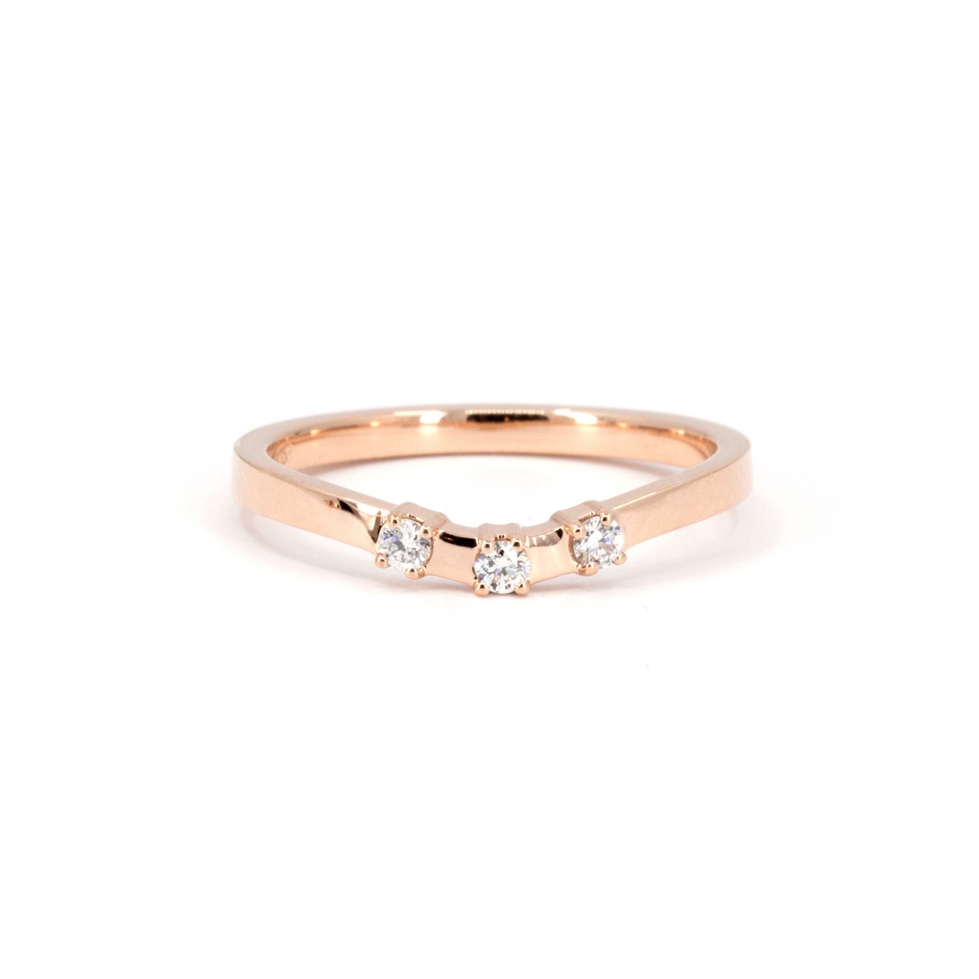 Detailed view of Bena Jewelry's rose gold diamond band, complementing the orange sapphire ring, on a white background.
