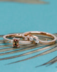 Detailed view of Bena Jewelry's rose gold diamond band, complementing the orange sapphire ring, on a white background.
