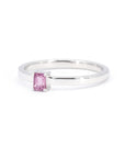 Boxy white gold ring with a vibrant pink sapphire in baguette cut, crafted by Bena Jewelry, a Montreal-based jewelry designer.