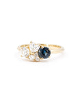 Front view of a bespoke blue spinel and diamond ring set in yellow gold, crafted by Bena Jewelry.