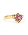 Close-up of Montreal-made pink sapphire ring with brown diamond halo, handcrafted in yellow gold by Bena Jewelry – edgy fine jewelry.