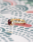 Ruby Flame Ring on soft-toned background – The deep red ruby glows against a warm-toned backdrop, enhancing its regal beauty.