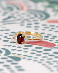 Ruby Flame Ring worn on hand, close-up – A timeless ruby engagement ring set in yellow gold, handcrafted in Montreal by Bena Jewelry.