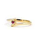 Close-up of the Kink Ruby ring showcasing its round blood-red ruby and twisted yellow gold band, designed by Bena Jewelry in Montreal.