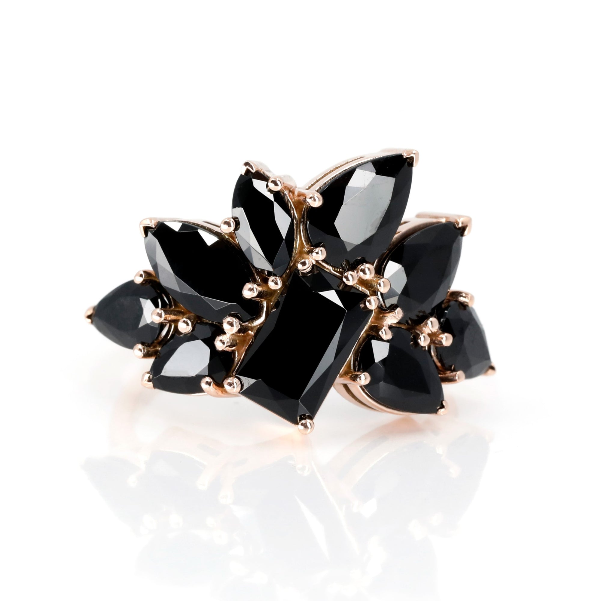 Front view of the Black Trombone Ring displaying the intricate arrangement of black tourmalines on the rose gold band. Made by Bena Jewelry, indepandant canadian desginer.