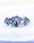 Top-down view: Displays the sapphire amalgamation and the seamless integration of the gemstones with the white gold band. Custom-made by Bena Jewelry in Montreal, Canada.
