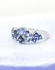 Close-up: Captures the vibrant hues of the sapphires and the smooth finish of the white gold setting. Made in Montreal, Canada, by independent designer Bena Jewelry.