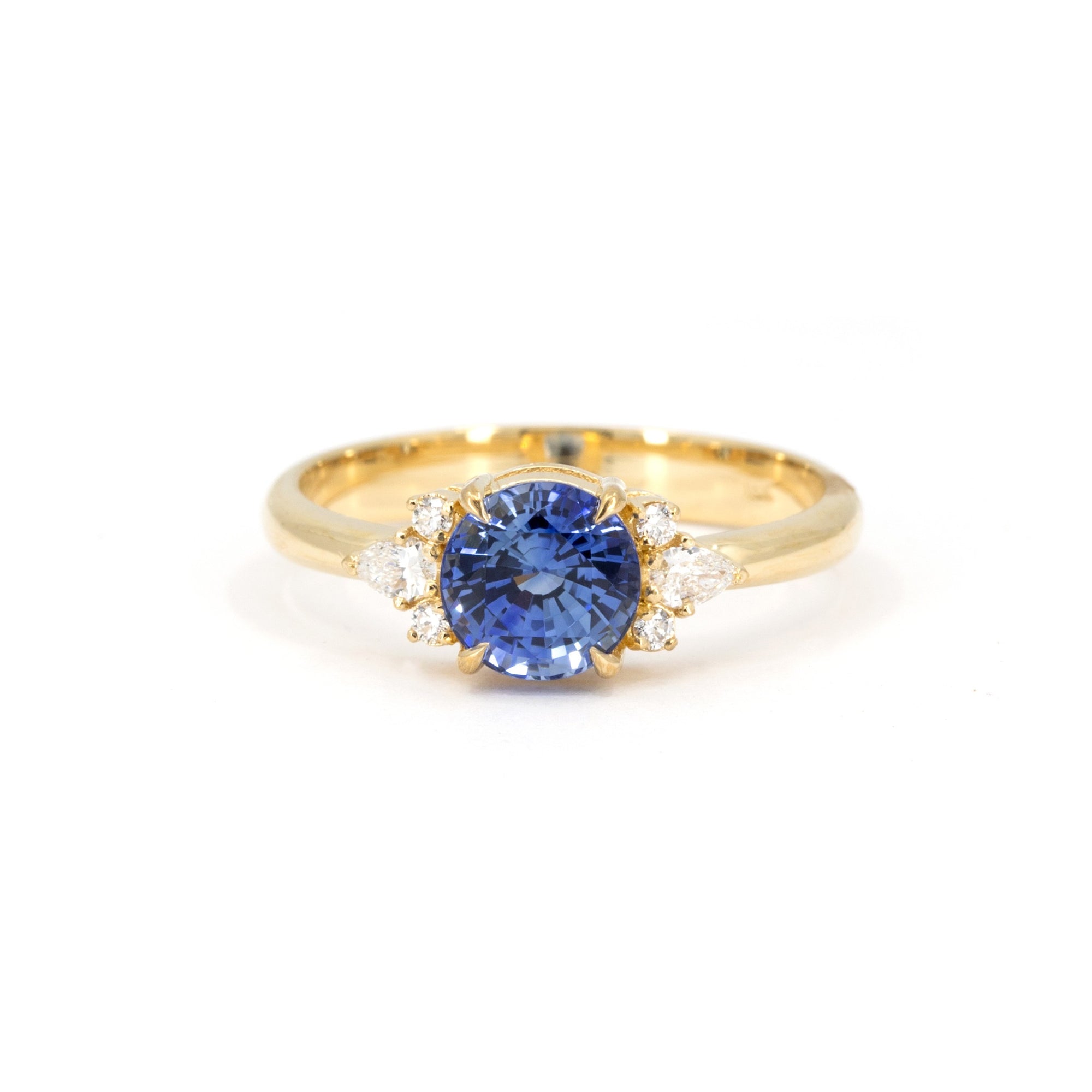 Azure Tide Sapphire & Diamond Ring on white background – A custom engagement ring featuring a vivid blue sapphire and pear-cut diamonds, designed by Bena Jewelry in Montreal.