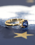 Angled shot of Azure Tide Sapphire & Diamond Ring – A refined engagement ring with an artistic arrangement of pear and round diamonds.