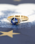 Side view of Azure Tide Sapphire & Diamond Ring – A handcrafted engagement ring showcasing a round blue sapphire and elegant diamond accents.