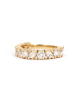 Close-up of marquise and round lab-grown diamonds set on a luxurious yellow gold eternity Bena Jewelry wedding band.