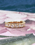 14 kt yellow gold wedding band with marquise and round lab-grown diamonds worn on the hand, showcasing its bold elegance crafted by Bena Jewelry designer.