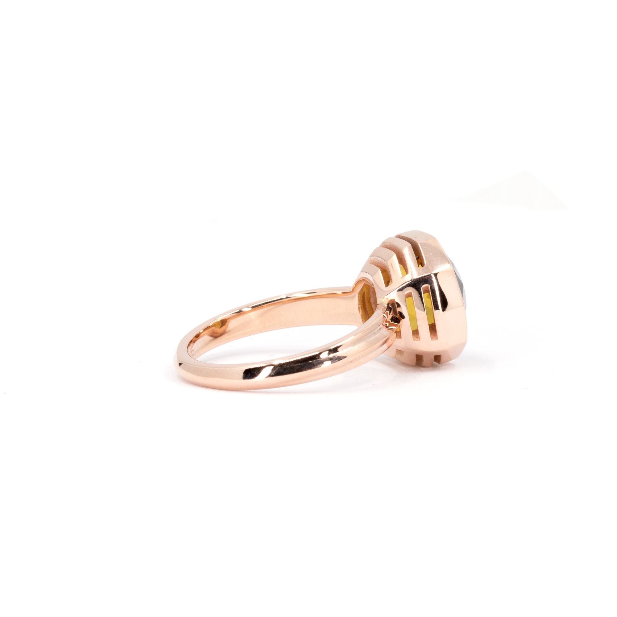 Back view of the vibrant orange citrine ring with substantial yellow gold volume, made by Bena Jewelry, displayed on a white surface.