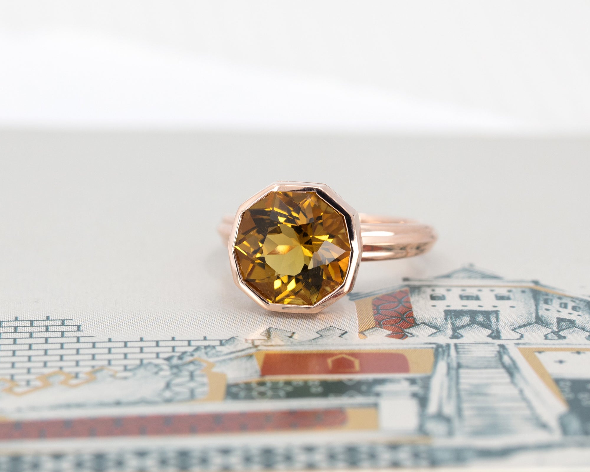 Front view of Bena Jewelry's bold and modern citrine ring, featuring an octagonal cut, highlighted by a colored backdrop.