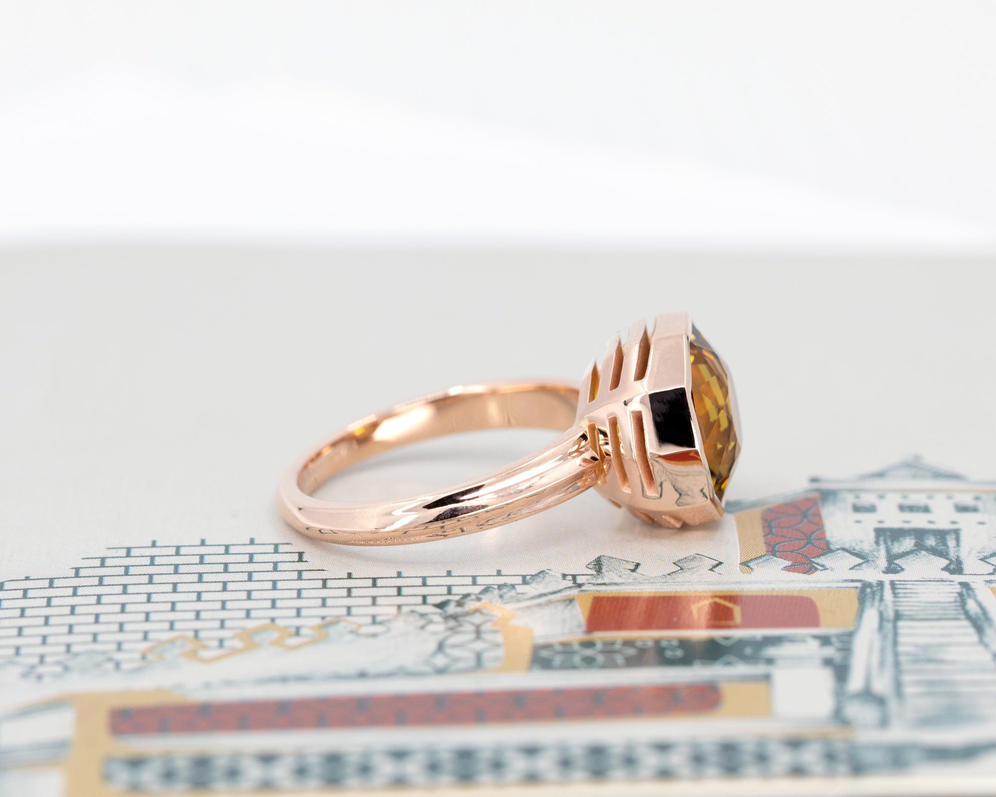 Bright orange citrine cocktail ring in yellow gold, from Fancy Edgy Collection, glowing against a dark colord background.
