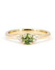 Cushion-cut green sapphire engagement ring with side diamonds in a timeless yellow gold setting. Made in Montreal by Bena Jewelry, fine bridal jewelry designer.