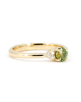 Side view of a timeless green sapphire engagement ring with diamonds. Handcrafted in Montreal by Bena Jewelry, a Canadian jewelry designer.