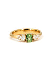 Designer ring featuring a vivid green cushion sapphire and lab-grown pear diamonds, mounted on yellow gold. Handmade in Montreal by Bena Jewelry, Canada.