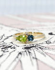 Close-up of the Peridot and Spinel Ring by Bena Jewelry – This bespoke ring showcases a contemporary setting with a harmonious mix of colored gemstones and diamonds.