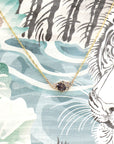 Close-up of the pendant worn, highlighting the asymmetrical design – A contemporary fine jewelry piece that blends structure and fluidity.