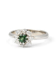 Side view of the Deep Forest Glow ring in 10k white gold, showcasing the intricate setting of the green sapphire and the detailed craftsmanship of the diamond arrangement.