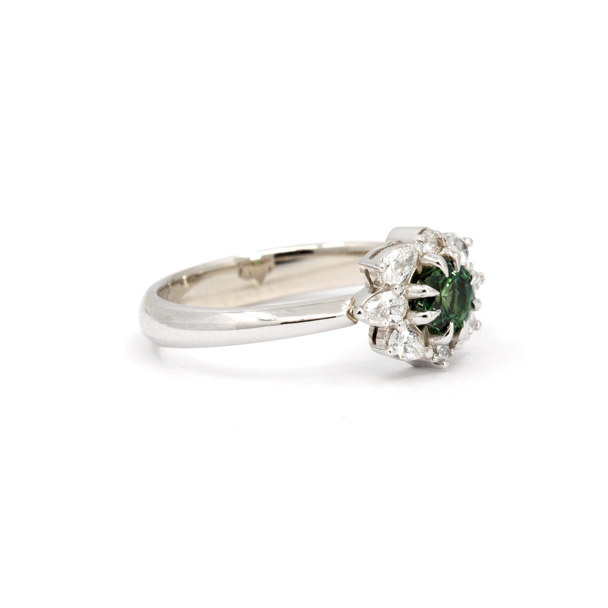Minimalist product shot of the Deep Forest Glow ring in 10k white gold. The deep green sapphire and delicate diamond accents create a striking contrast, highlighting its vintage-inspired elegance.