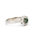 Minimalist product shot of the Deep Forest Glow ring in 10k white gold. The deep green sapphire and delicate diamond accents create a striking contrast, highlighting its vintage-inspired elegance.